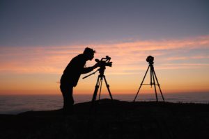 Silhouette of a camera operator against the sunset